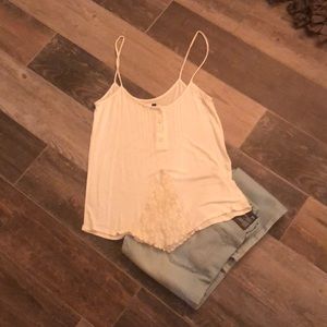 Cream colored tank with lace and button accents